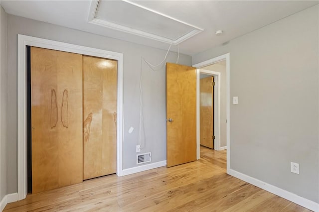 1717 Gina Dr, West Mifflin, PA 15122 - unfurnished bedroom featuring attic access, wood finished floors, and a closet