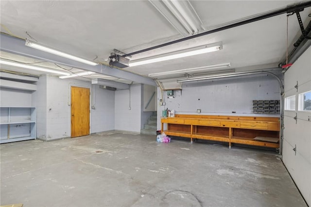 1717 Gina Dr, West Mifflin, PA 15122 - garage featuring a garage door opener and a workshop area