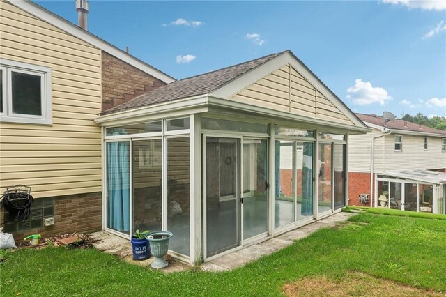 1717 Gina Dr, West Mifflin, PA 15122 - view of side of home with a sunroom, a shingled roof, and a yard
