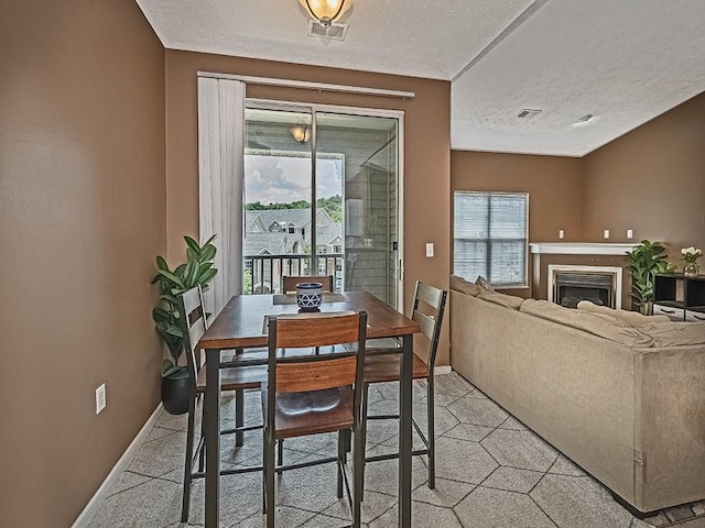 310 Stockton Rdg, Cranberry Twp, PA 16066 - dining space with plenty of natural light, a textured ceiling, and a fireplace