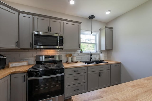 190 Hillview Manor Rd, Gilpin Twp, PA 15656 - kitchen with appliances with stainless steel finishes, gray cabinetry, wooden counters, tasteful backsplash, and pendant lighting
