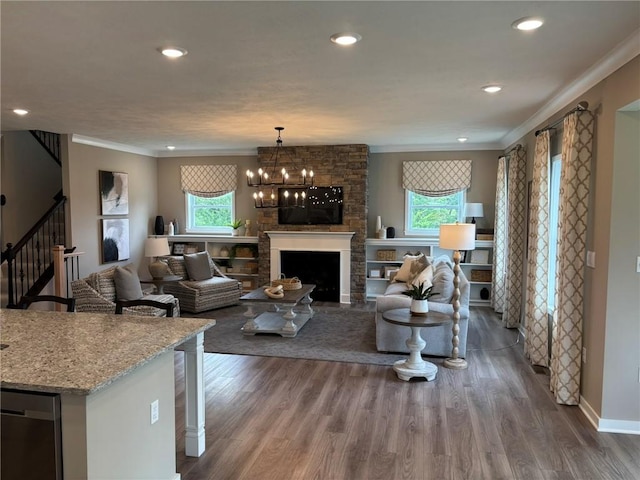 116 Mesa Dr, Moon/Crescent Twp, PA 15108 - living room with wood finished floors, crown molding, stairway, a chandelier, and a fireplace
