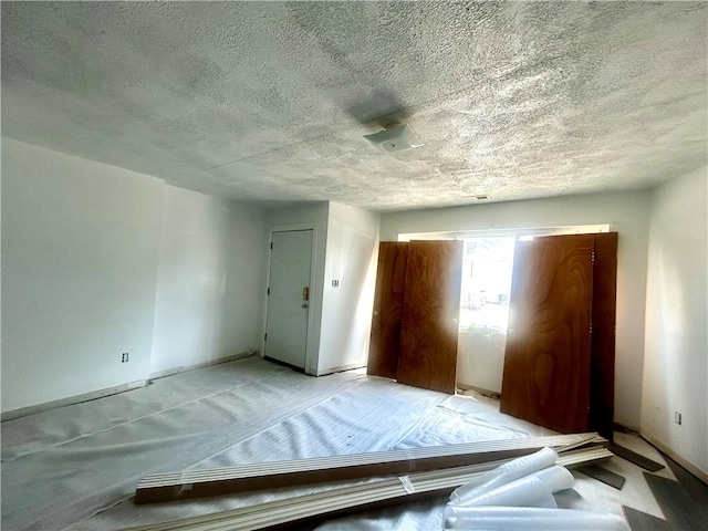 1411 Walnut Ave, Monessen, PA 15062 - unfurnished bedroom featuring a textured ceiling