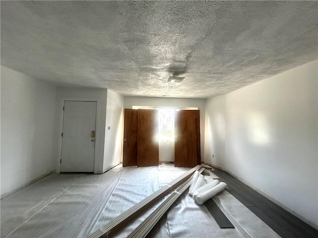 1411 Walnut Ave, Monessen, PA 15062 - unfurnished bedroom featuring a textured ceiling