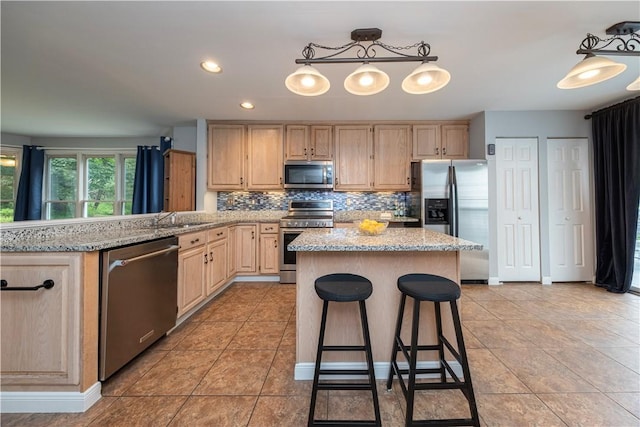 314 Westburn Ct, Seven Fields Boro, PA 16046 - kitchen featuring stainless steel appliances, light brown cabinetry, decorative backsplash, a kitchen island, and light stone counters