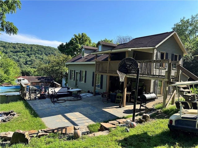 108 Hill St, Coaldale, PA 16679 - rear view of house featuring a patio area, a deck, roof with shingles, and a forest view