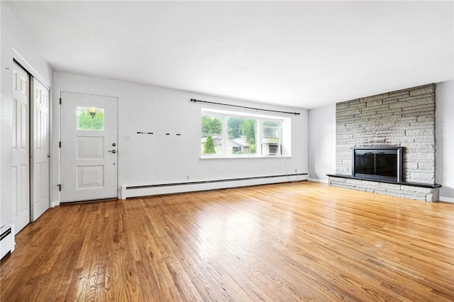 110 Marian Ave, Shaler, PA 15116 - unfurnished living room with a baseboard radiator, plenty of natural light, wood finished floors, and a stone fireplace