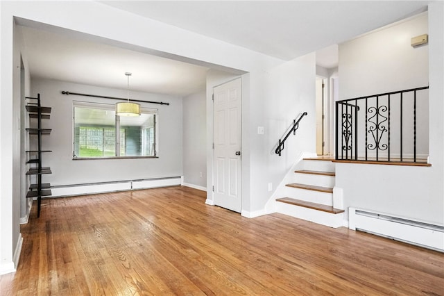 110 Marian Ave, Shaler, PA 15116 - unfurnished living room featuring baseboard heating, hardwood / wood-style flooring, and stairway