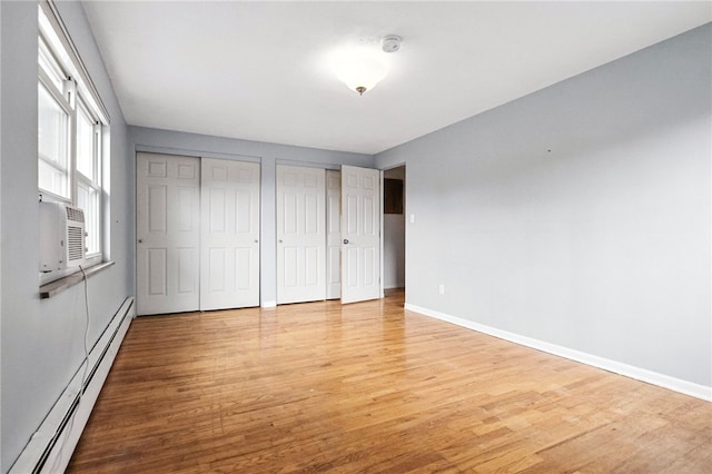 110 Marian Ave, Shaler, PA 15116 - unfurnished bedroom with a baseboard heating unit, two closets, light wood-style flooring, and cooling unit