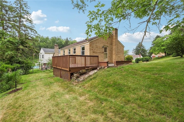 106 Crestline Dr, Ross Twp, PA 15237 - back of house featuring a chimney, brick siding, a deck, and a lawn