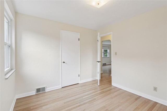 106 Crestline Dr, Ross Twp, PA 15237 - empty room with arched walkways and light wood finished floors