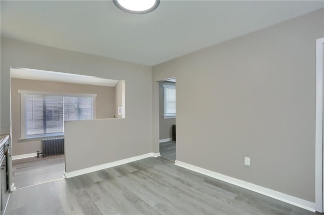 505 Bellwood Rd, West Mifflin, PA 15122 - spare room featuring radiator, plenty of natural light, and wood finished floors