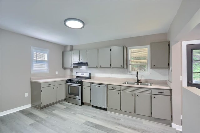 505 Bellwood Rd, West Mifflin, PA 15122 - kitchen with stainless steel appliances, under cabinet range hood, gray cabinets, light wood-style flooring, and light countertops