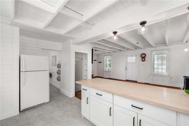 221 Connoquenessing Main St, Connoquenessing Boro, PA 16027 - kitchen with freestanding refrigerator, white cabinets, beamed ceiling, and light countertops