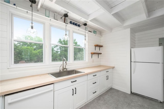 221 Connoquenessing Main St, Connoquenessing Boro, PA 16027 - kitchen featuring white appliances, beamed ceiling, white cabinets, pendant lighting, and light countertops