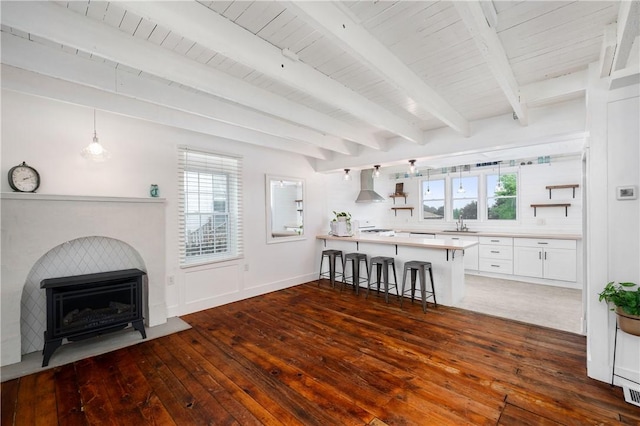 221 Connoquenessing Main St, Connoquenessing Boro, PA 16027 - living room with wood-type flooring, healthy amount of natural light, a fireplace with flush hearth, and a wooden ceiling with exposed beams