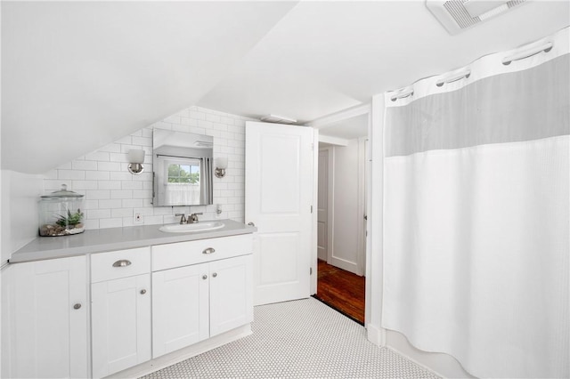 221 Connoquenessing Main St, Connoquenessing Boro, PA 16027 - bathroom with vanity, tasteful backsplash, curtained shower, and vaulted ceiling