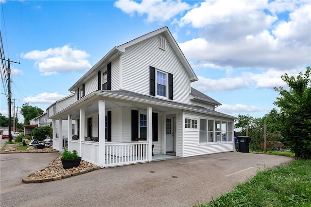 221 Connoquenessing Main St, Connoquenessing Boro, PA 16027 - farmhouse inspired home with covered porch, roof with shingles, and asphalt driveway