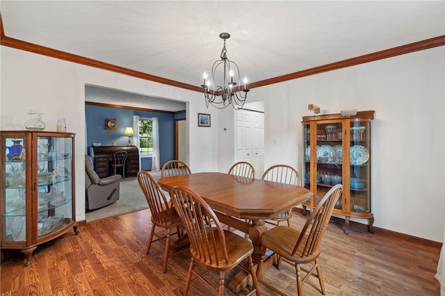 215 Lafayette Dr, Cranberry Twp, PA 16066 - dining room featuring a chandelier, light wood-style flooring, and crown molding