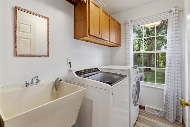 215 Lafayette Dr, Cranberry Twp, PA 16066 - laundry area with cabinet space, healthy amount of natural light, washing machine and dryer, and light wood-style floors