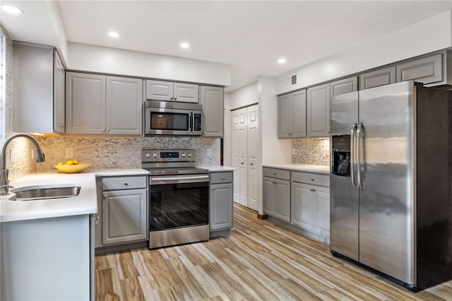 215 Lafayette Dr, Cranberry Twp, PA 16066 - kitchen with appliances with stainless steel finishes, gray cabinetry, light wood finished floors, light countertops, and recessed lighting