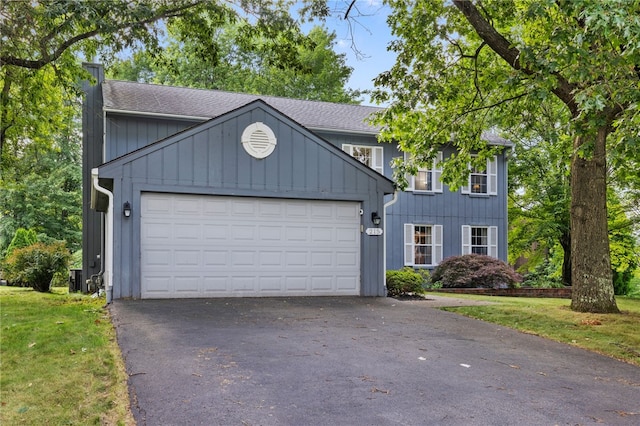 215 Lafayette Dr, Cranberry Twp, PA 16066 - view of front facade featuring an attached garage, roof with shingles, asphalt driveway, and a front yard