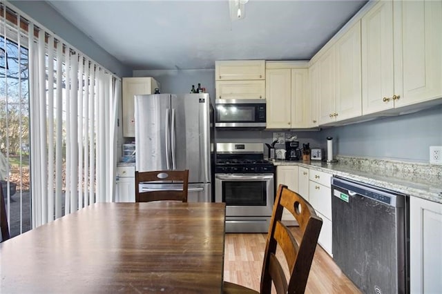 206 7th St, Oakmont, PA 15139 - kitchen with stainless steel appliances, light wood finished floors, and light stone countertops