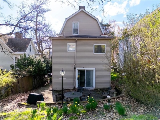 206 7th St, Oakmont, PA 15139 - back of property featuring a gambrel roof, a chimney, and a patio