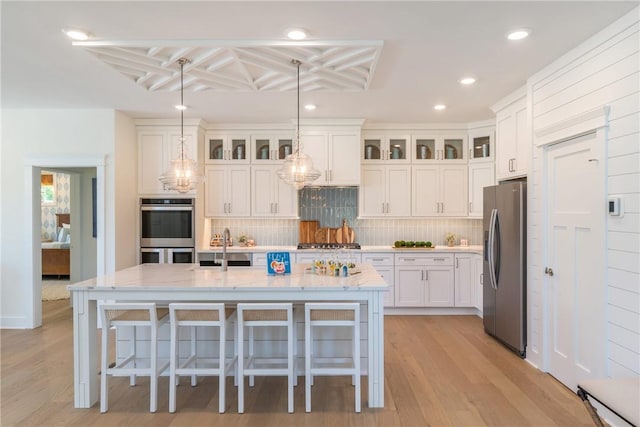287 Mcmurray Rd, Saint Clair, PA 15241 - kitchen featuring appliances with stainless steel finishes, white cabinets, tasteful backsplash, light wood-type flooring, and recessed lighting
