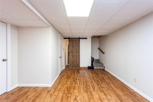 12220 Herold Dr, North Huntingdon, PA 15642 - finished below grade area with a barn door, light wood-style floors, and stairway