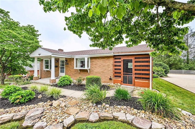 12220 Herold Dr, North Huntingdon, PA 15642 - view of front facade with brick siding and a chimney