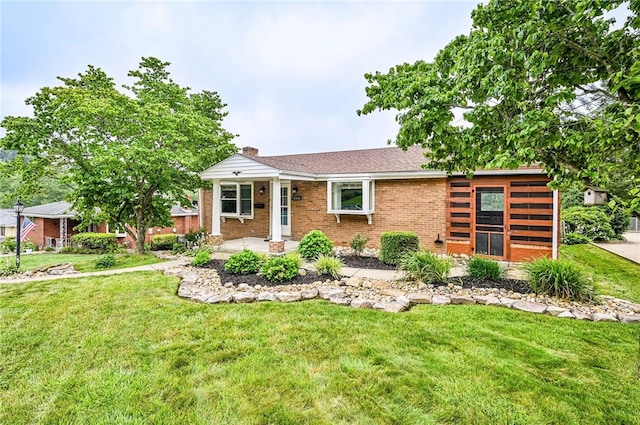 12220 Herold Dr, North Huntingdon, PA 15642 - view of front of home featuring a front lawn, brick siding, and a chimney