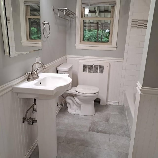 120 Rothen Ave, Twp Of But Nw, PA 16001 - full bathroom featuring radiator heating unit, a wainscoted wall,  shower combination, stone finish floors, and a decorative wall