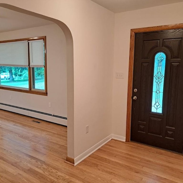 120 Rothen Ave, Twp Of But Nw, PA 16001 - entrance foyer with a baseboard heating unit, light wood-style flooring, and arched walkways