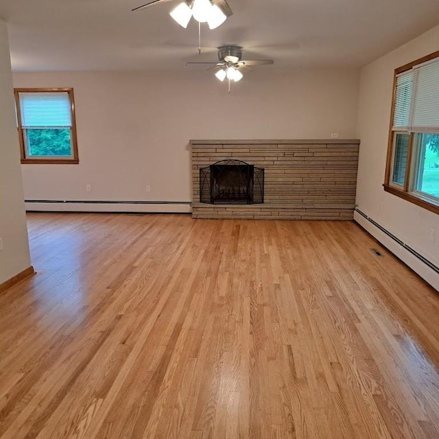 120 Rothen Ave, Twp Of But Nw, PA 16001 - unfurnished living room with baseboard heating, light wood-type flooring, a ceiling fan, and healthy amount of natural light