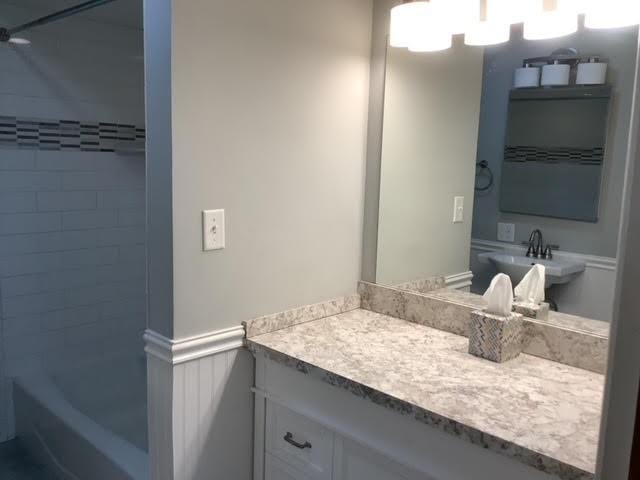 120 Rothen Ave, Twp Of But Nw, PA 16001 - bathroom with shower / bathtub combination, a wainscoted wall, and vanity