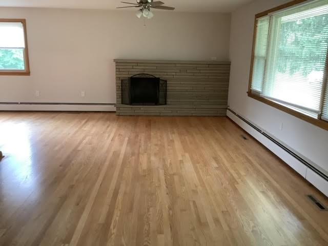 120 Rothen Ave, Twp Of But Nw, PA 16001 - unfurnished living room with a baseboard radiator, plenty of natural light, and ceiling fan
