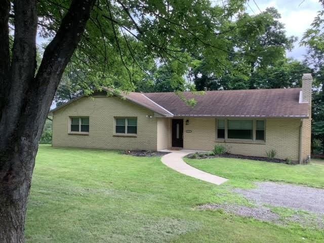 120 Rothen Ave, Twp Of But Nw, PA 16001 - ranch-style house featuring a front yard, a chimney, and brick siding