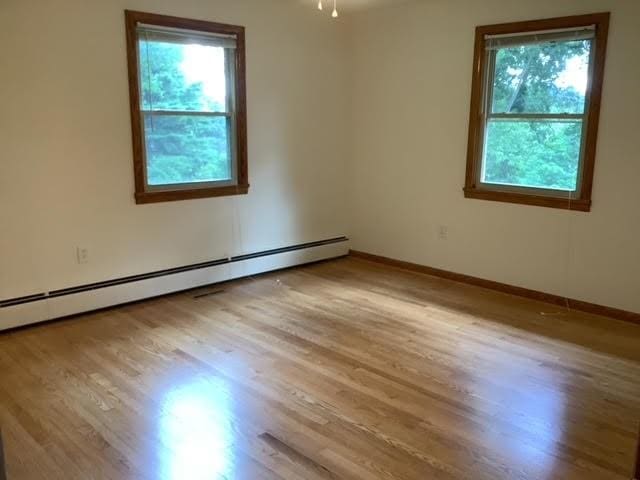 120 Rothen Ave, Twp Of But Nw, PA 16001 - spare room featuring healthy amount of natural light, baseboard heating, and wood finished floors