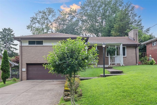 4952 Flamingo Dr, Whitehall, PA 15236 - ranch-style home with concrete driveway, brick siding, a garage, a front yard, and a porch