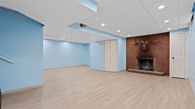 4952 Flamingo Dr, Whitehall, PA 15236 - unfurnished living room featuring a brick fireplace, wood finished floors, a drop ceiling, and recessed lighting