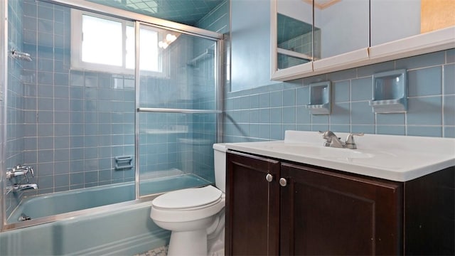 4952 Flamingo Dr, Whitehall, PA 15236 - bathroom featuring tile walls, vanity, enclosed tub / shower combo, and decorative backsplash