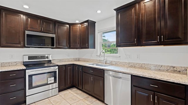 4952 Flamingo Dr, Whitehall, PA 15236 - kitchen featuring stainless steel appliances, dark brown cabinetry, light stone countertops, recessed lighting, and light tile patterned flooring