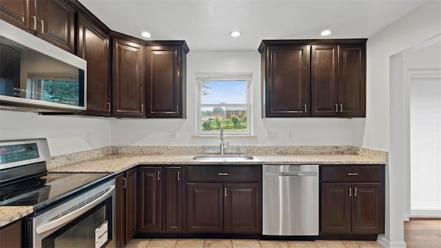 4952 Flamingo Dr, Whitehall, PA 15236 - kitchen featuring stainless steel appliances, light stone countertops, recessed lighting, and dark brown cabinets