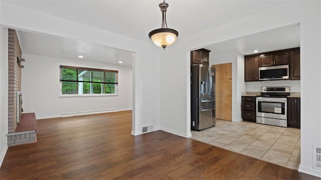 4952 Flamingo Dr, Whitehall, PA 15236 - kitchen with stainless steel appliances, baseboard heating, dark brown cabinets, open floor plan, and light wood-style floors