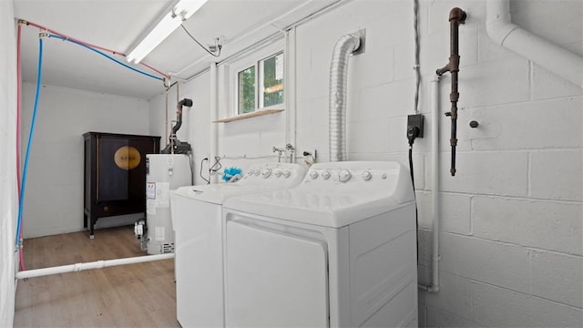 4952 Flamingo Dr, Whitehall, PA 15236 - washroom with water heater, washer and clothes dryer, light wood finished floors, and concrete block wall