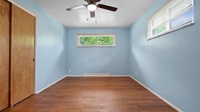 4952 Flamingo Dr, Whitehall, PA 15236 - unfurnished bedroom featuring a closet, wood finished floors, a baseboard radiator, and a ceiling fan