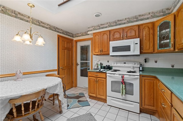 1146 Middletown, Hempfield Twp, PA 15601 - kitchen with white appliances, a chandelier, wallpapered walls, brown cabinets, and tasteful backsplash