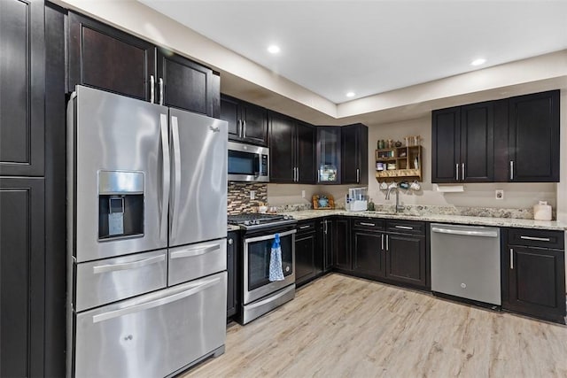 4673 Mill Stream Ct, Murrysville, PA 15668 - kitchen with appliances with stainless steel finishes, light stone counters, light wood-style flooring, recessed lighting, and dark cabinets