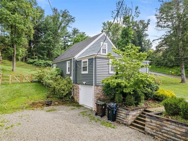 4673 Mill Stream Ct, Murrysville, PA 15668 - view of property exterior with stone siding, an attached garage, driveway, and a shingled roof